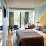 Dvivietis kambarys su aukso spalvos elementais ir žaliais akcentais